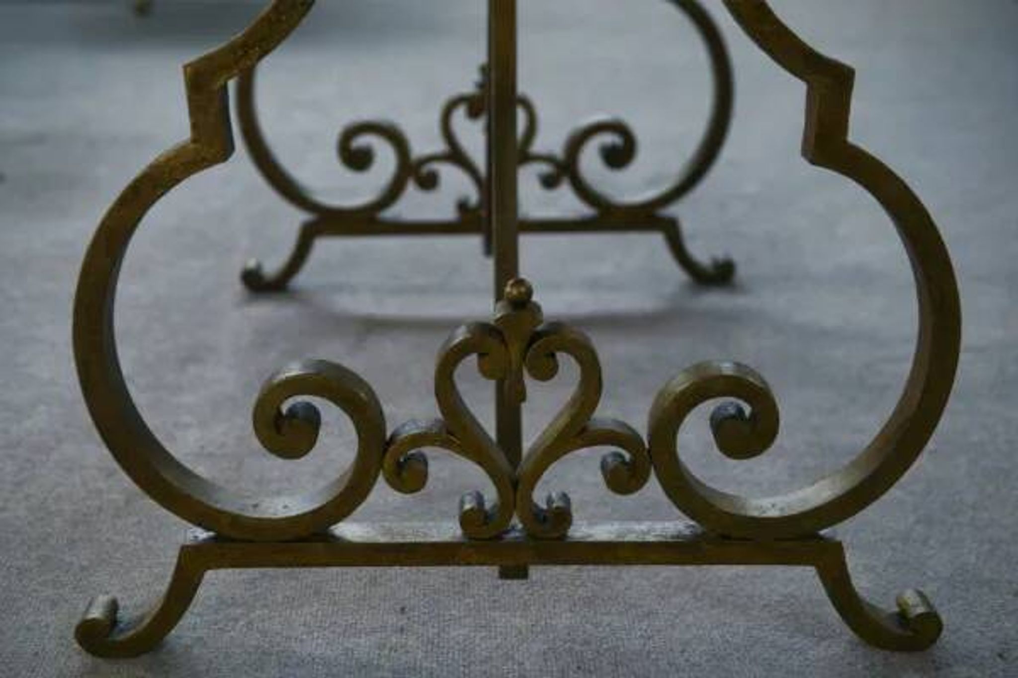 Side table with a gilt wrought iron base attributed to Gilbert Poillerat, with a travertine top, 1940s