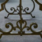 Side table with a gilt wrought iron base attributed to Gilbert Poillerat, with a travertine top, 1940s