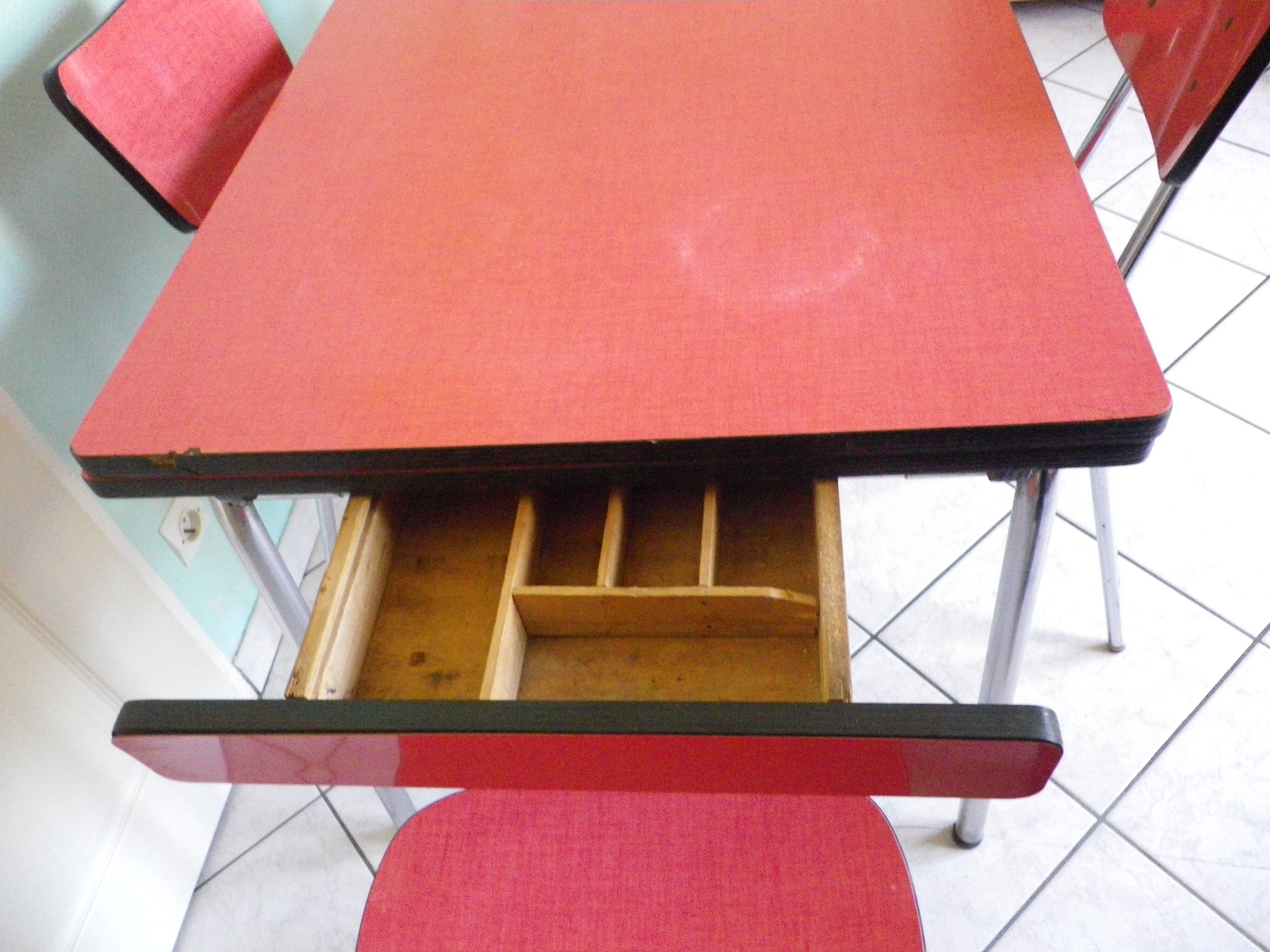 Table in red formica, 4 roc chairs, 2 extension cords, 2 drawers 60