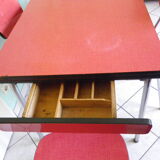 Table in red formica, 4 roc chairs, 2 extension cords, 2 drawers 60