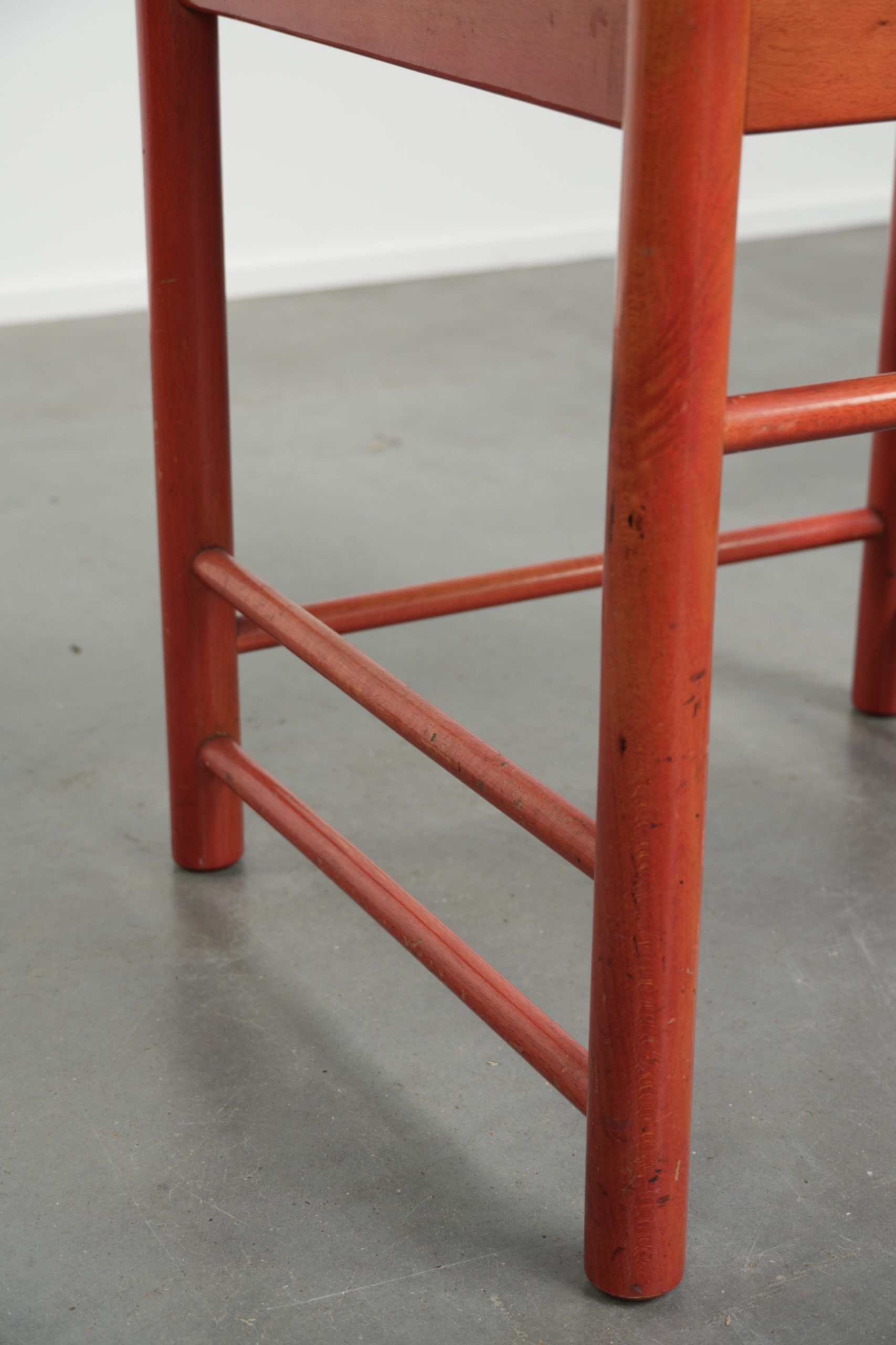 Nice red vintage wooden chair from the 1970s with a woven wicker seat