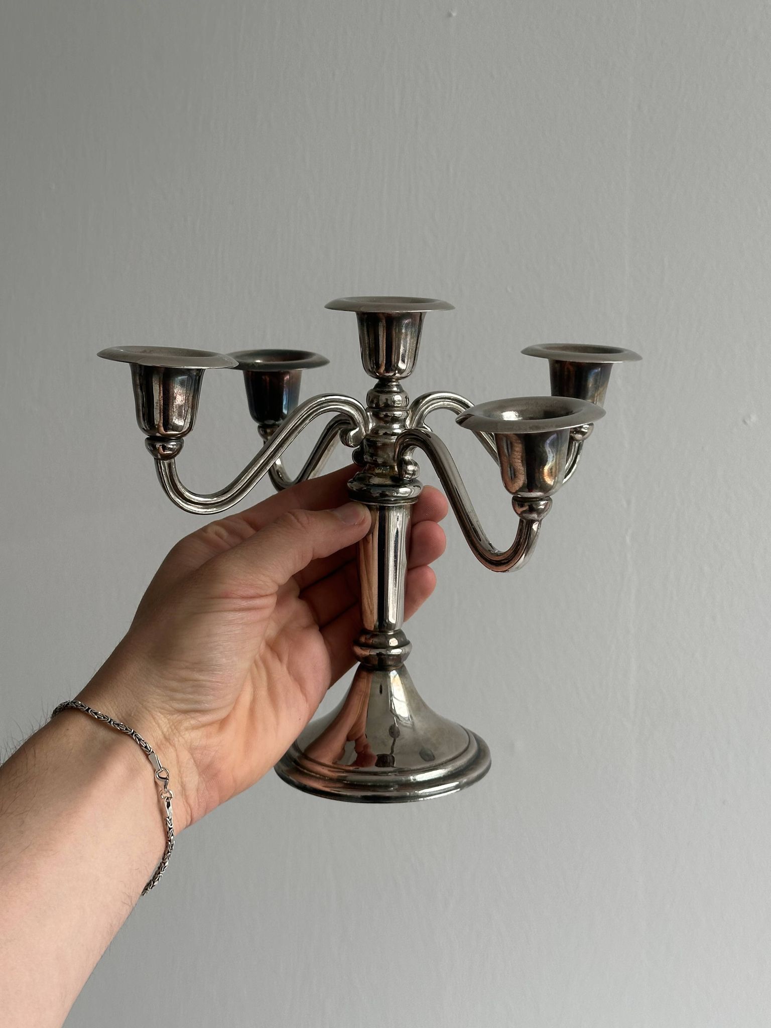 Candlestick candle holder in patinated silver metal