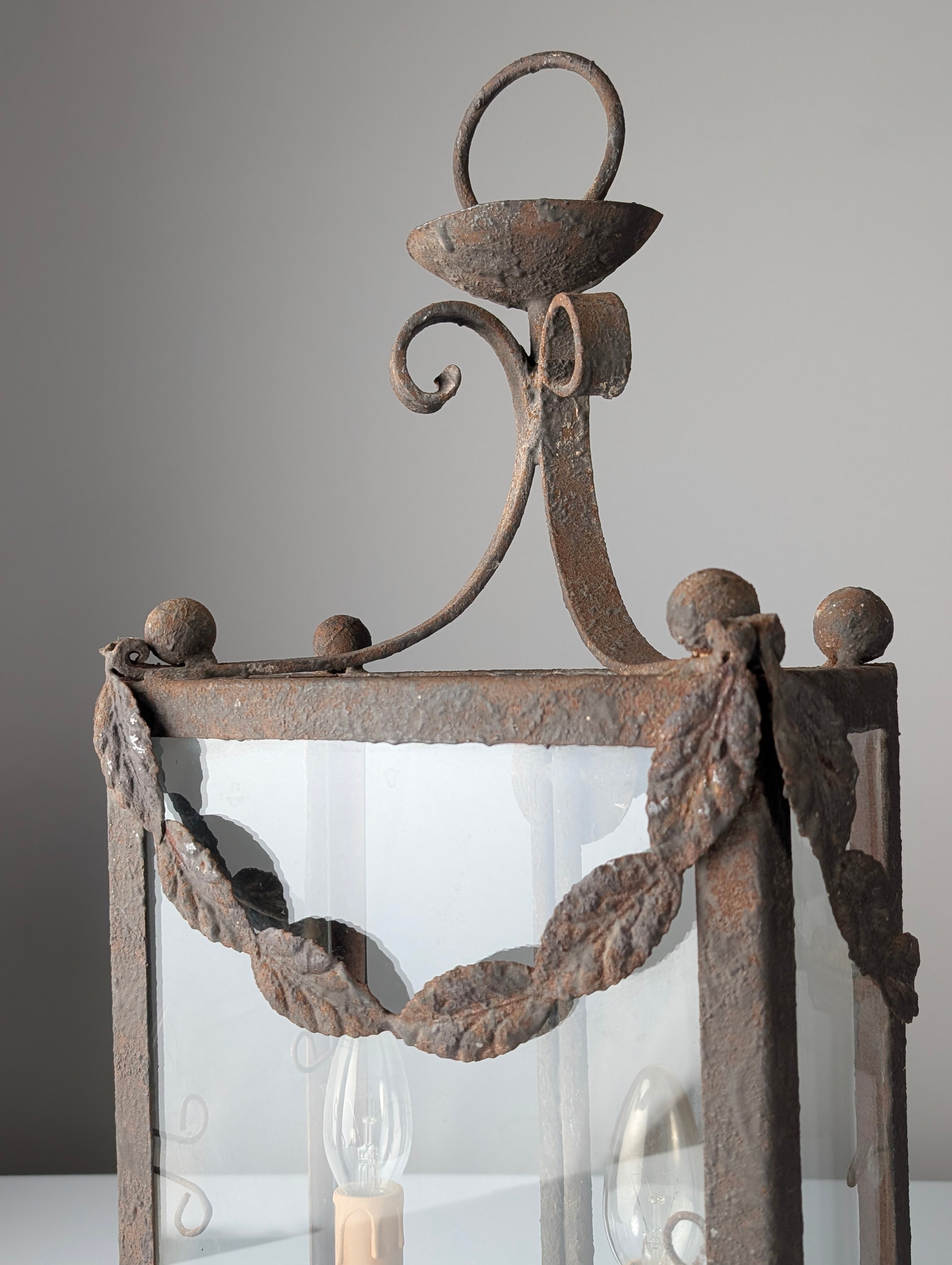 Wrought iron lantern with glass panels, leaf motifs