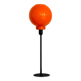 Table lamp with a vintage orange globe and a black base