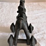 Old child's toy. Horse with bronze wheels. Ethnic object.