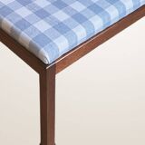 Ottoman coffee table in wood and gingham fabric.