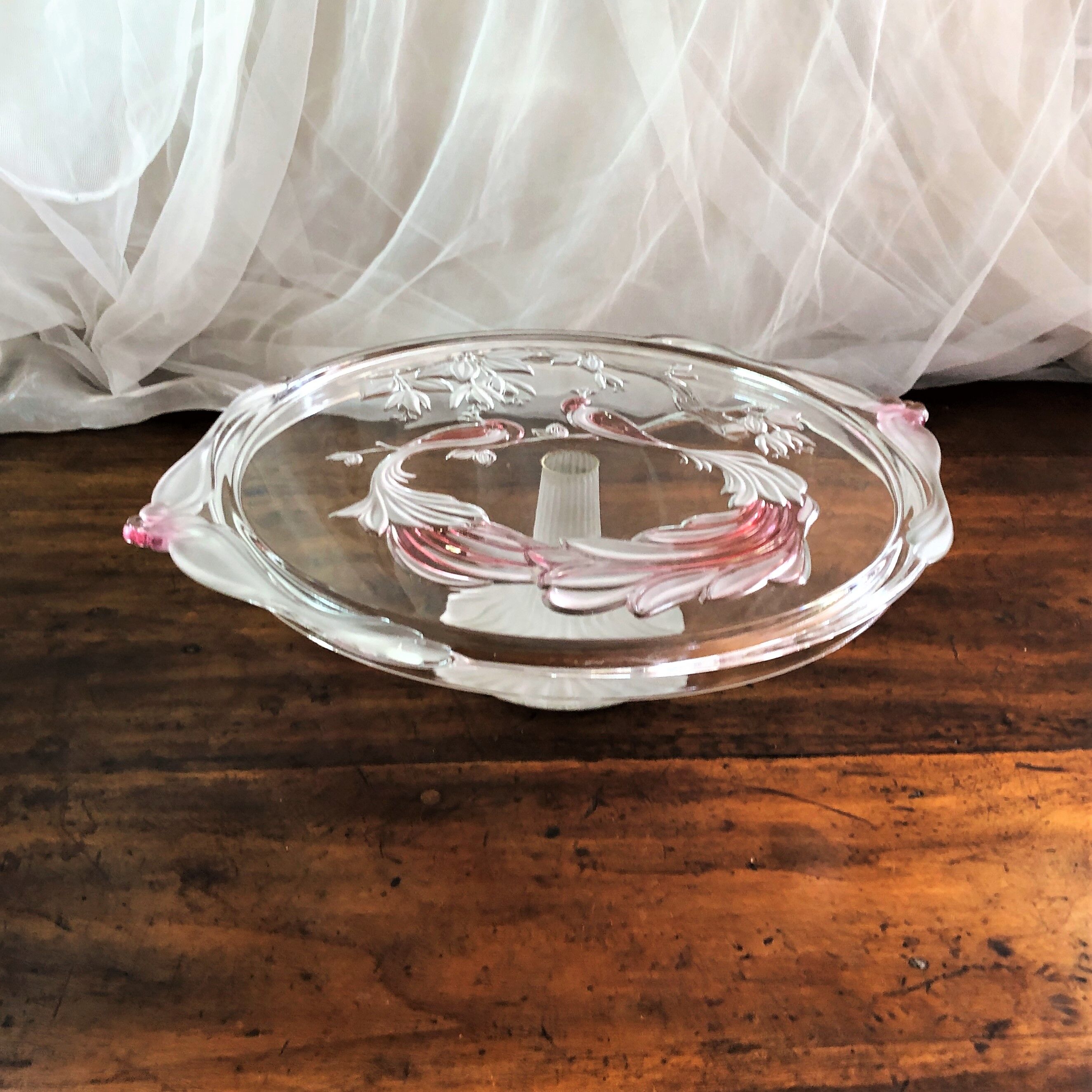Large pie dish cakes on pedestal decorated with peacocks