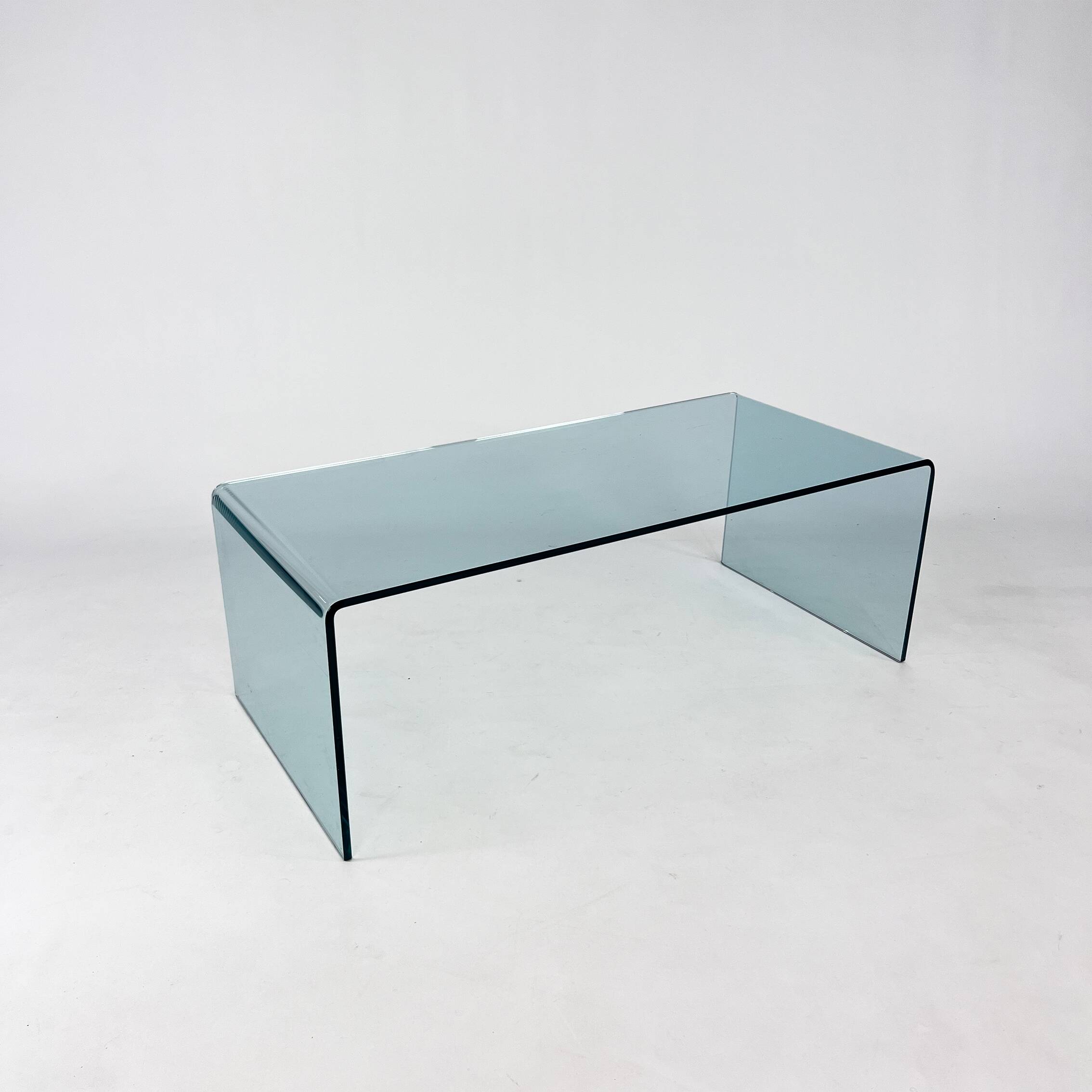 Postmodern coffee table made entirely of glass. Modernist and bitches minimalist look.