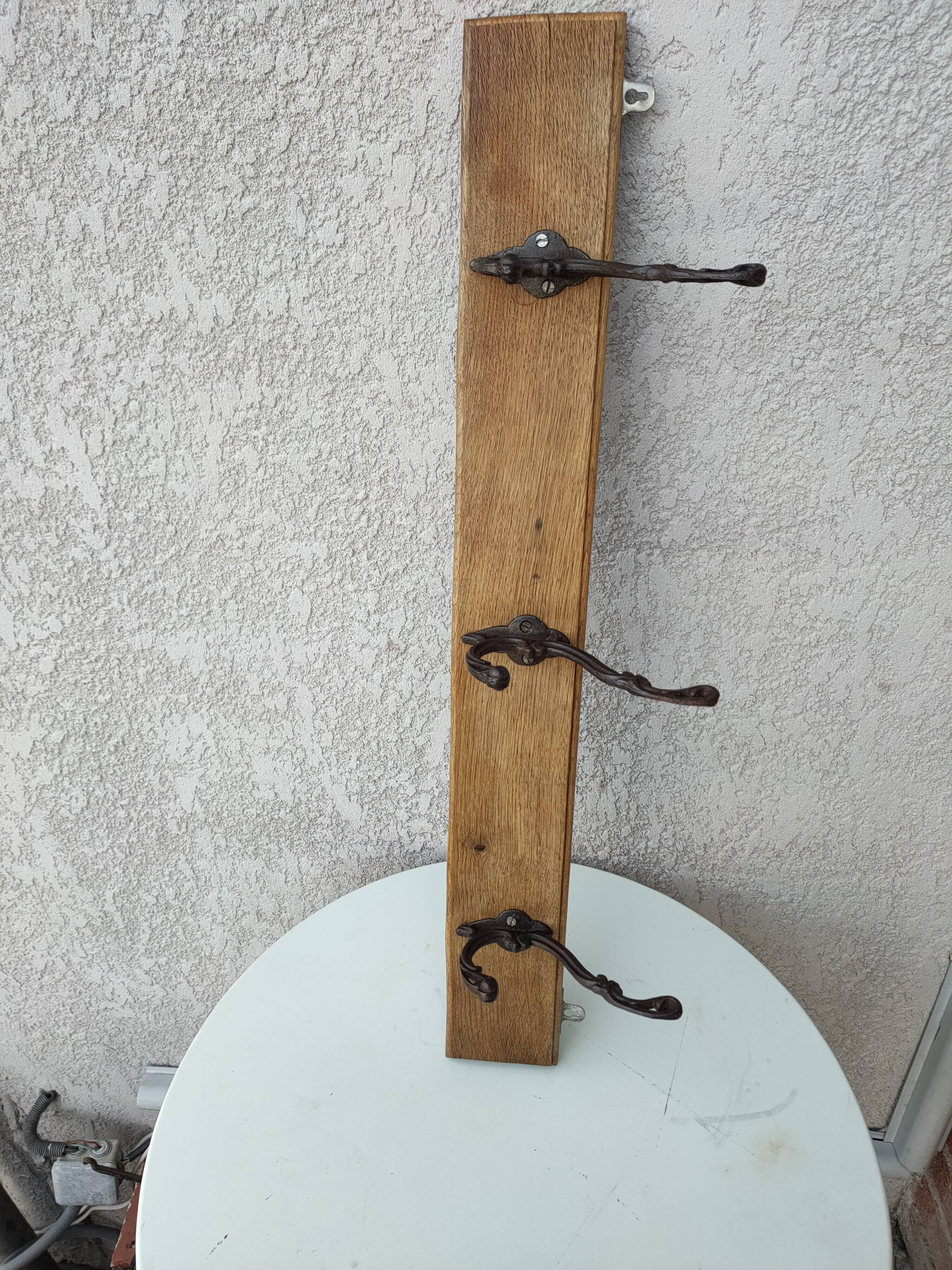 antique coat rack with 3 cast iron hooks