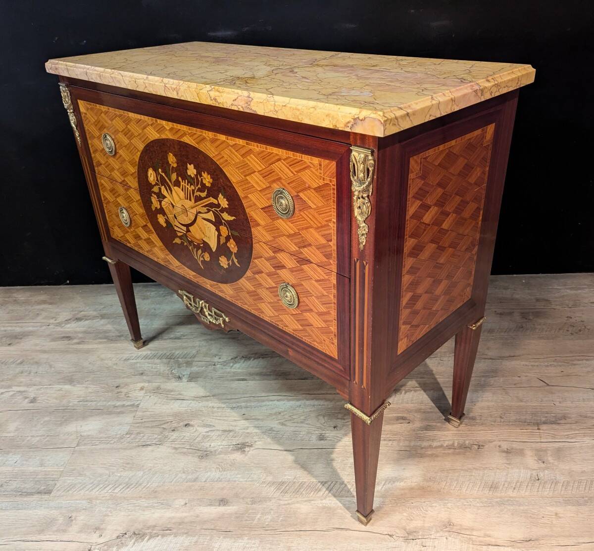 Louis XVI style commode inlaid with a decoration of instruments.