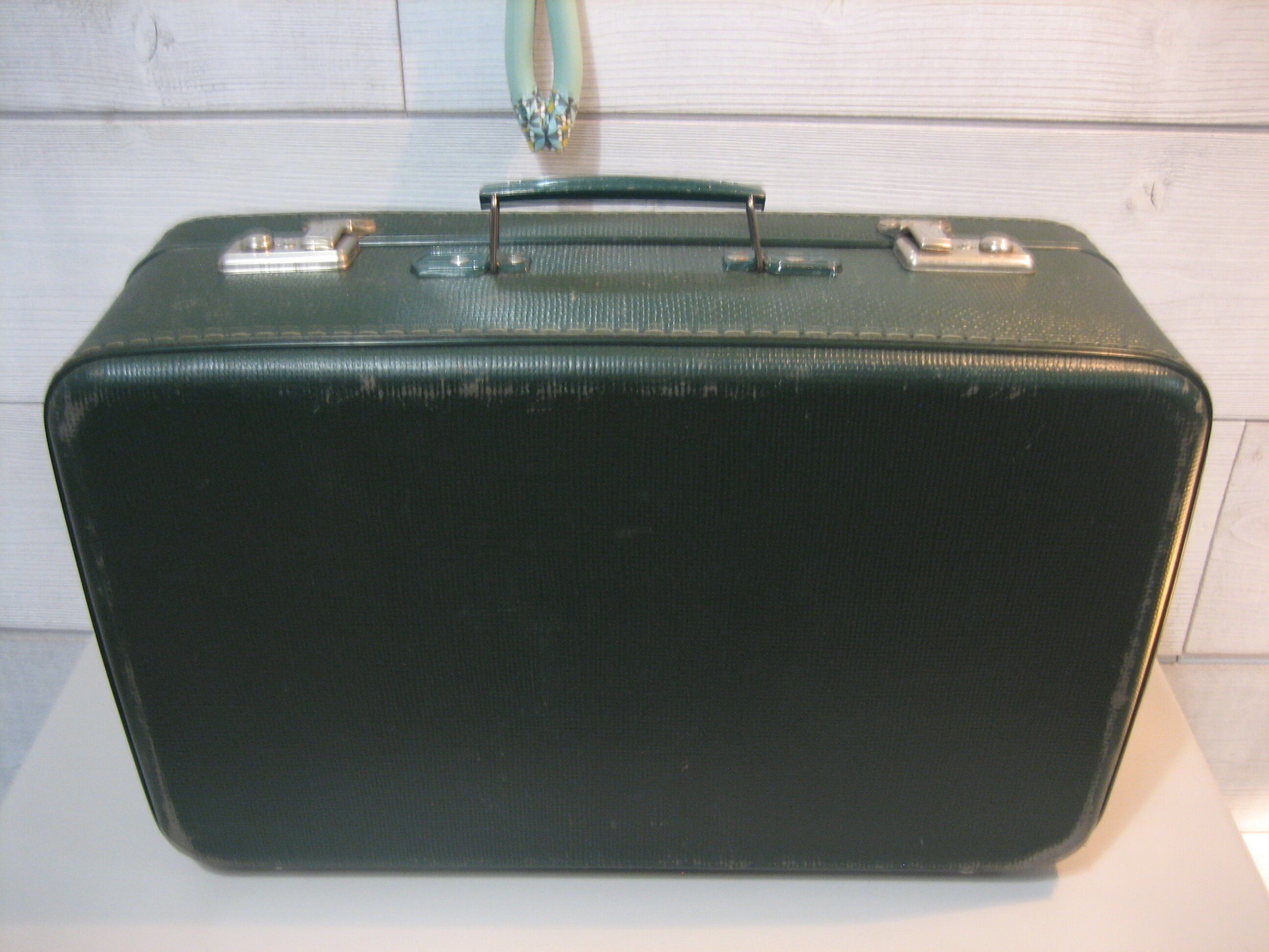 Dark green suitcase