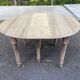 Round extendable dining table with flaps, stripped in raw oak, with 3 extensions.