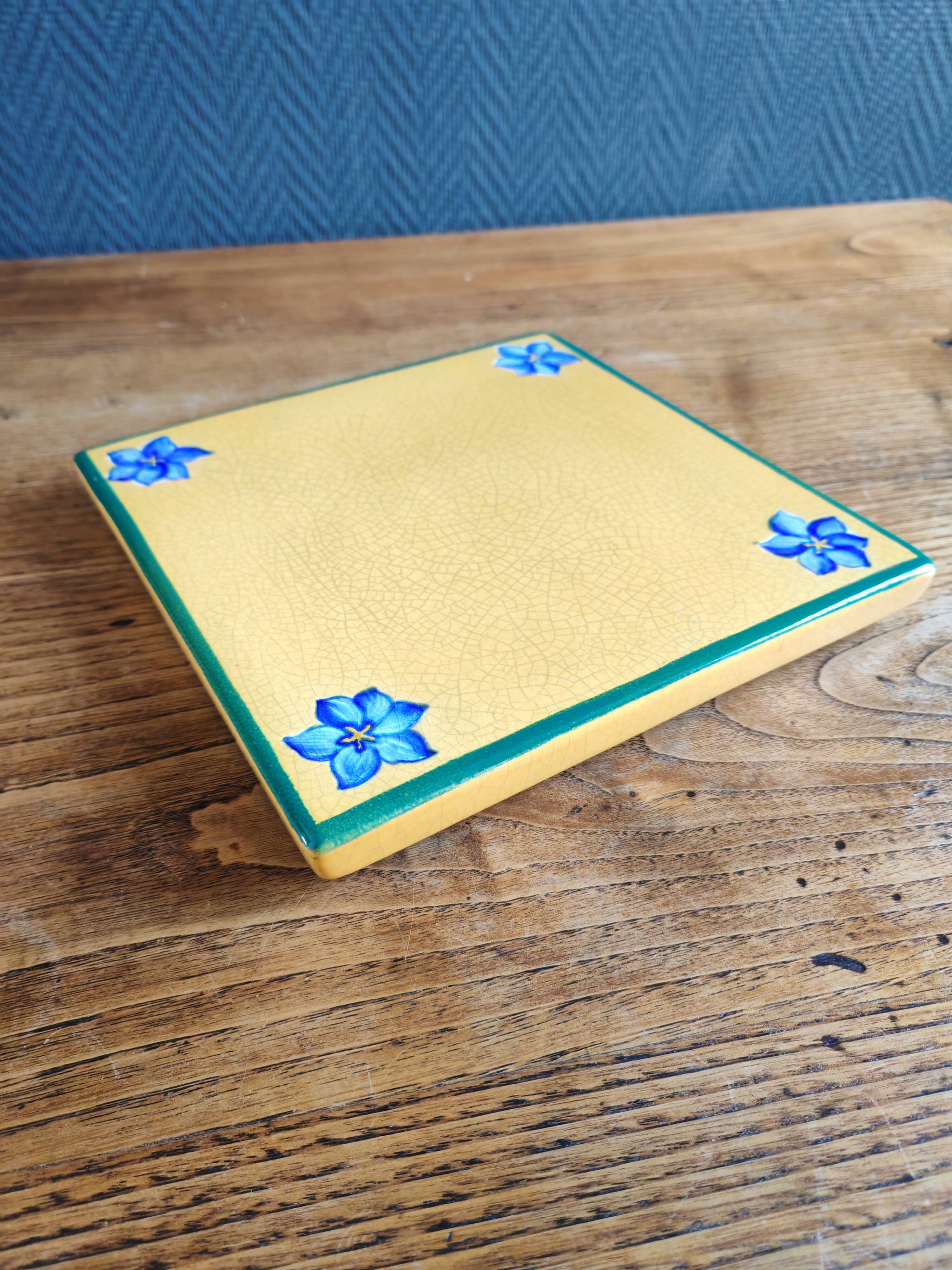 Yellow glazed ceramic trivet signed l. drimmer