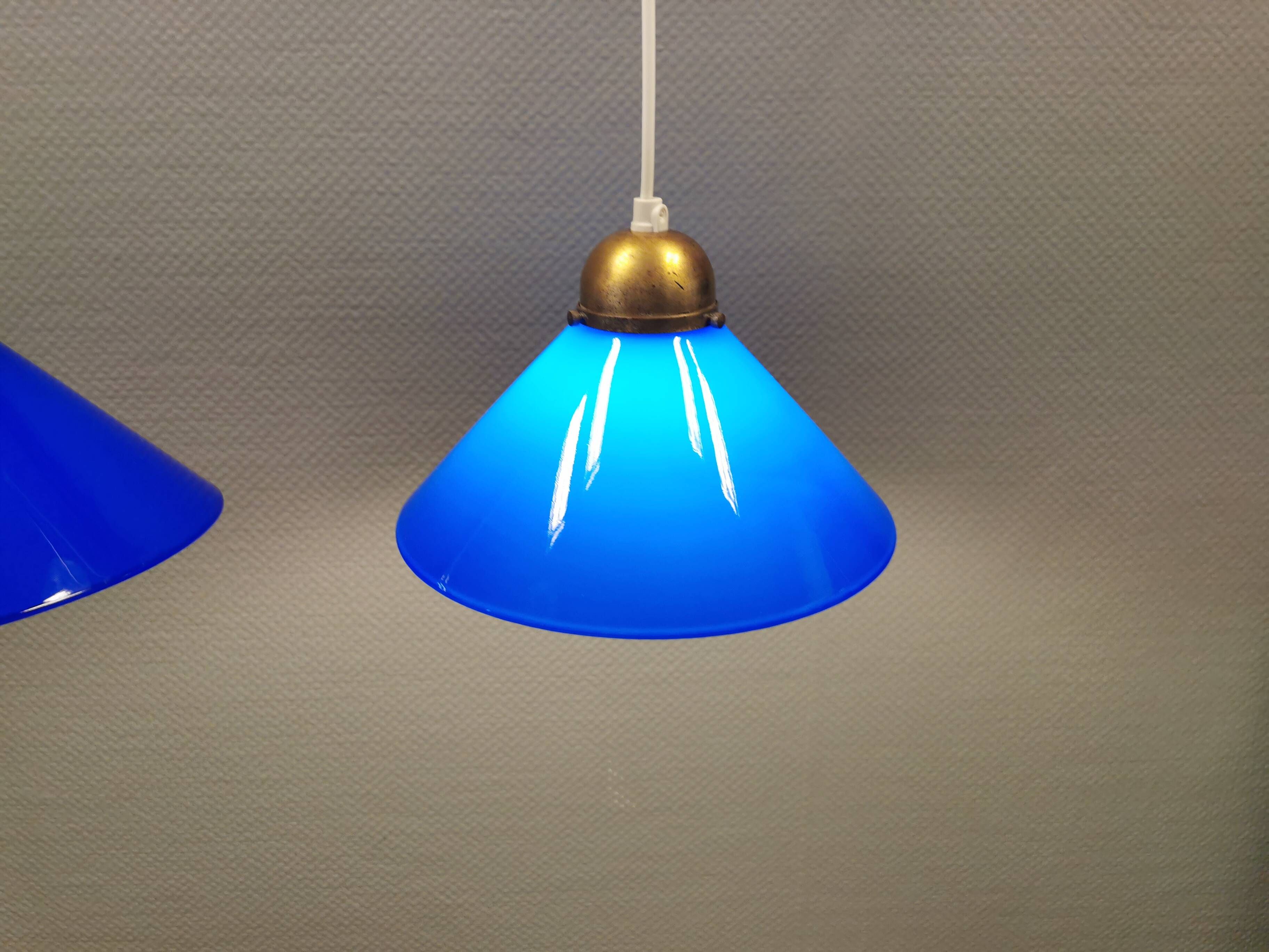 Two lamps in double layered glass with brass top. Danish and estimated from the 1960s
