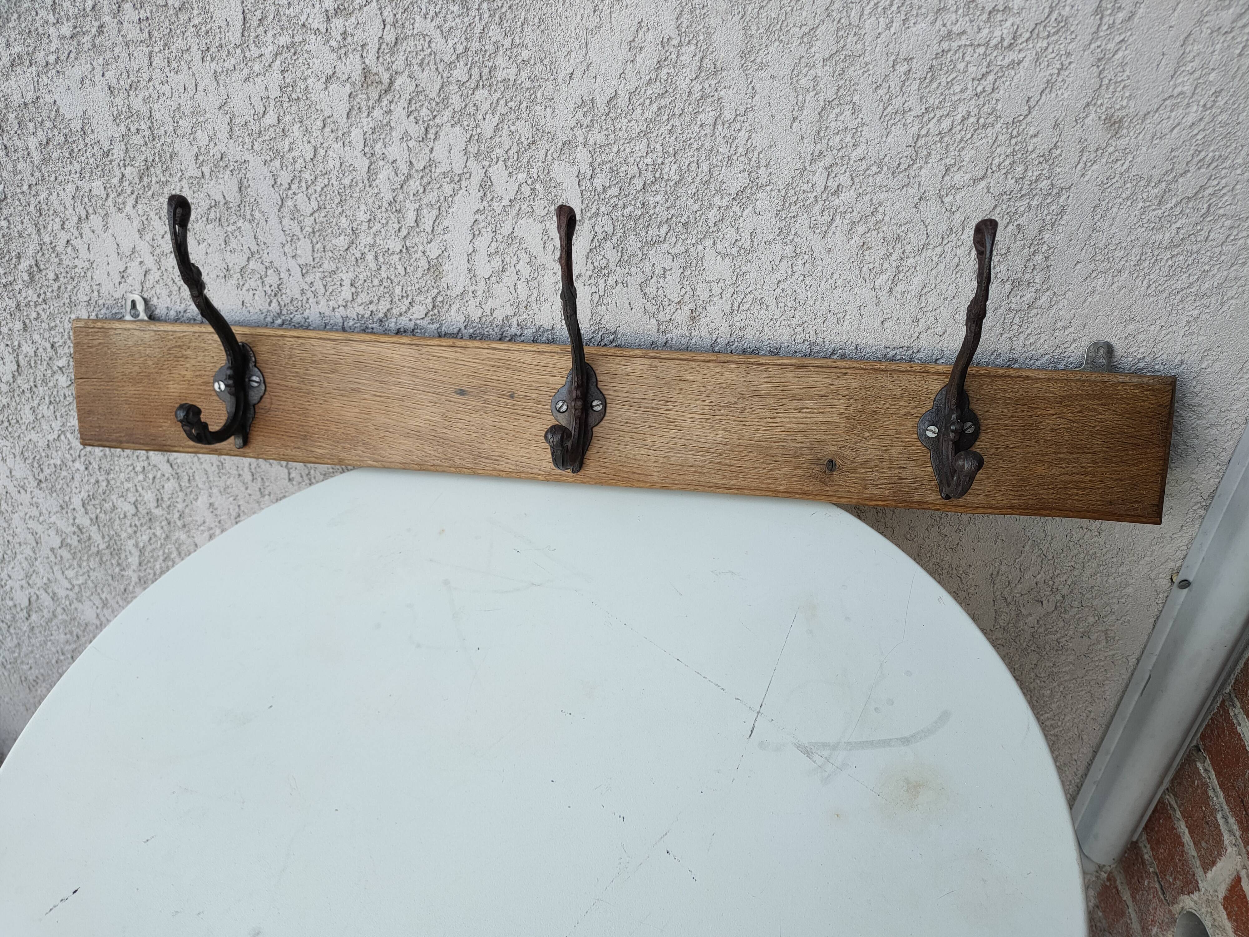 antique coat rack with 3 cast iron hooks