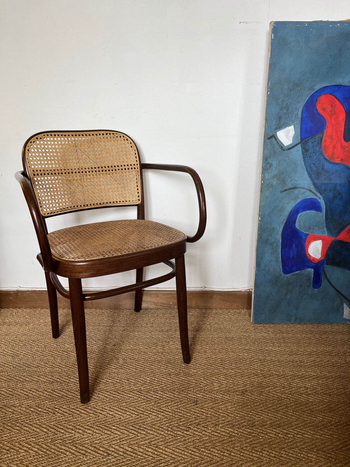 Curved wood and cane armchair