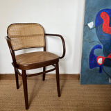 Curved wood and cane armchair