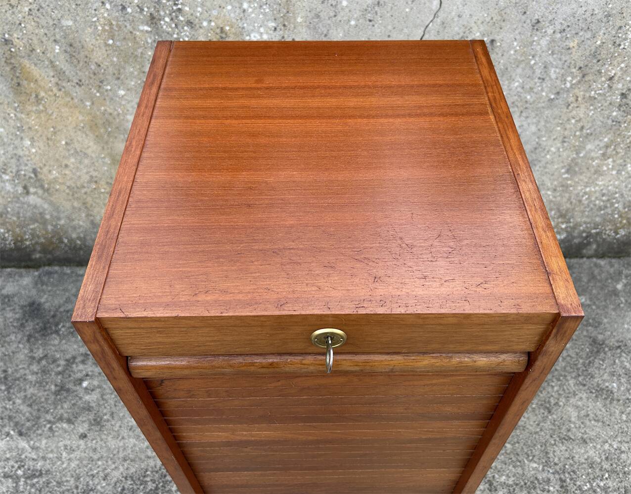 Vintage wooden filing cabinet with curtains.