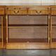 Vintage buffet made of mottled yew wood with three doors and four drawers.