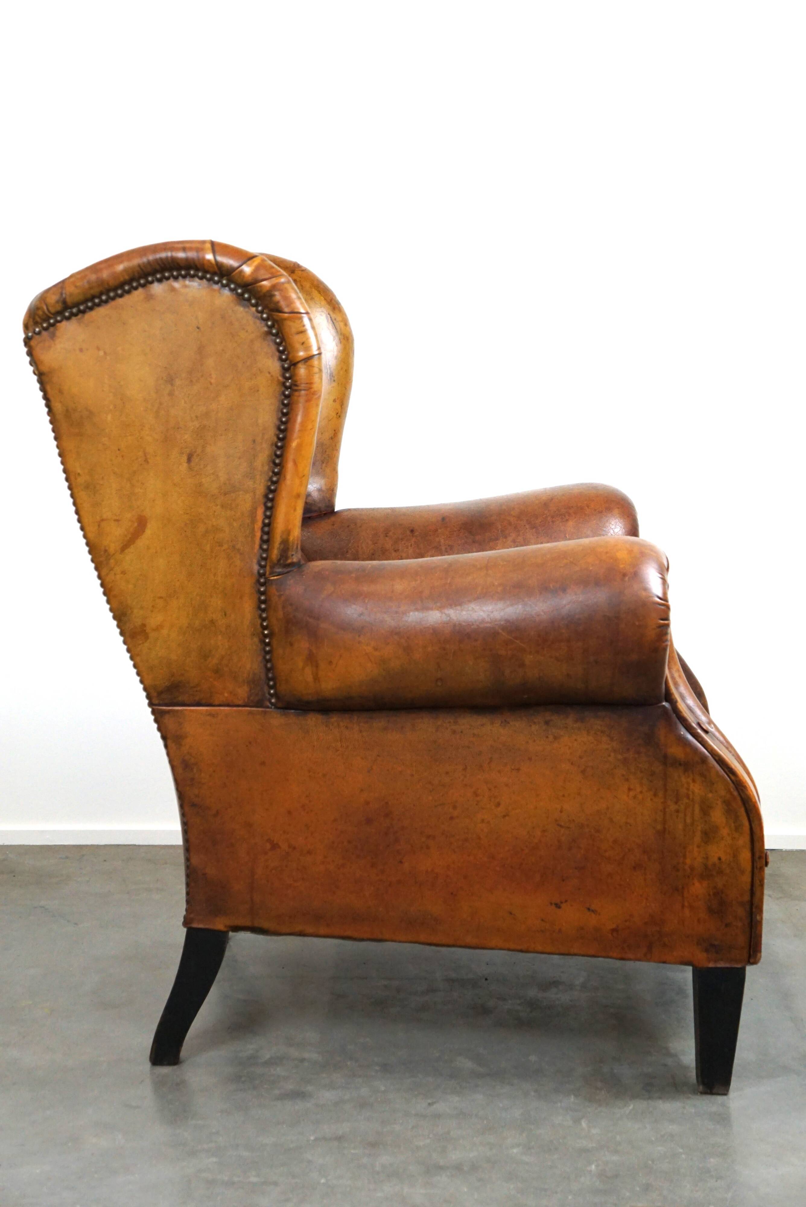 Irresistible old sheep leather wingback armchair with the most beautiful colors