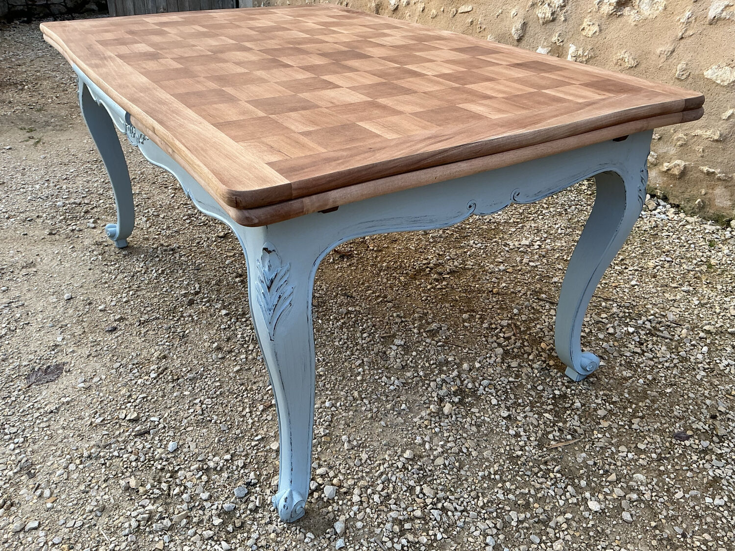 Louis XV style walnut table with a natural wood top.