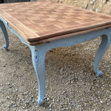 Louis XV style walnut table with a natural wood top.