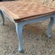 Louis XV style walnut table with a natural wood top.