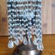 Metal candle holder with white glass tassels
