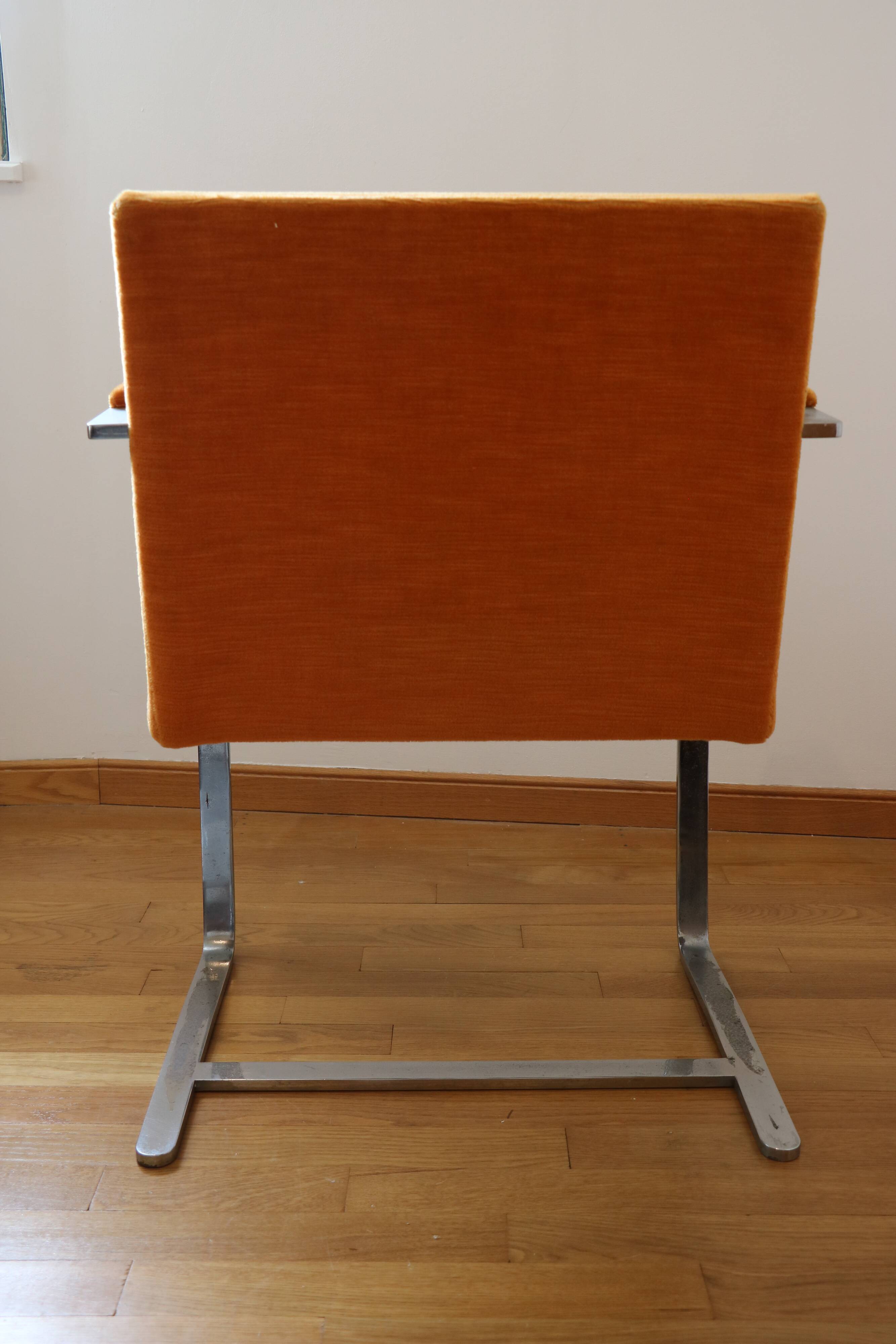 Chrome-plated metal and orange fabric armchair, 1970