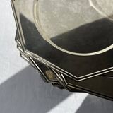 Many octagonal presentation plates in silver-plated metal.