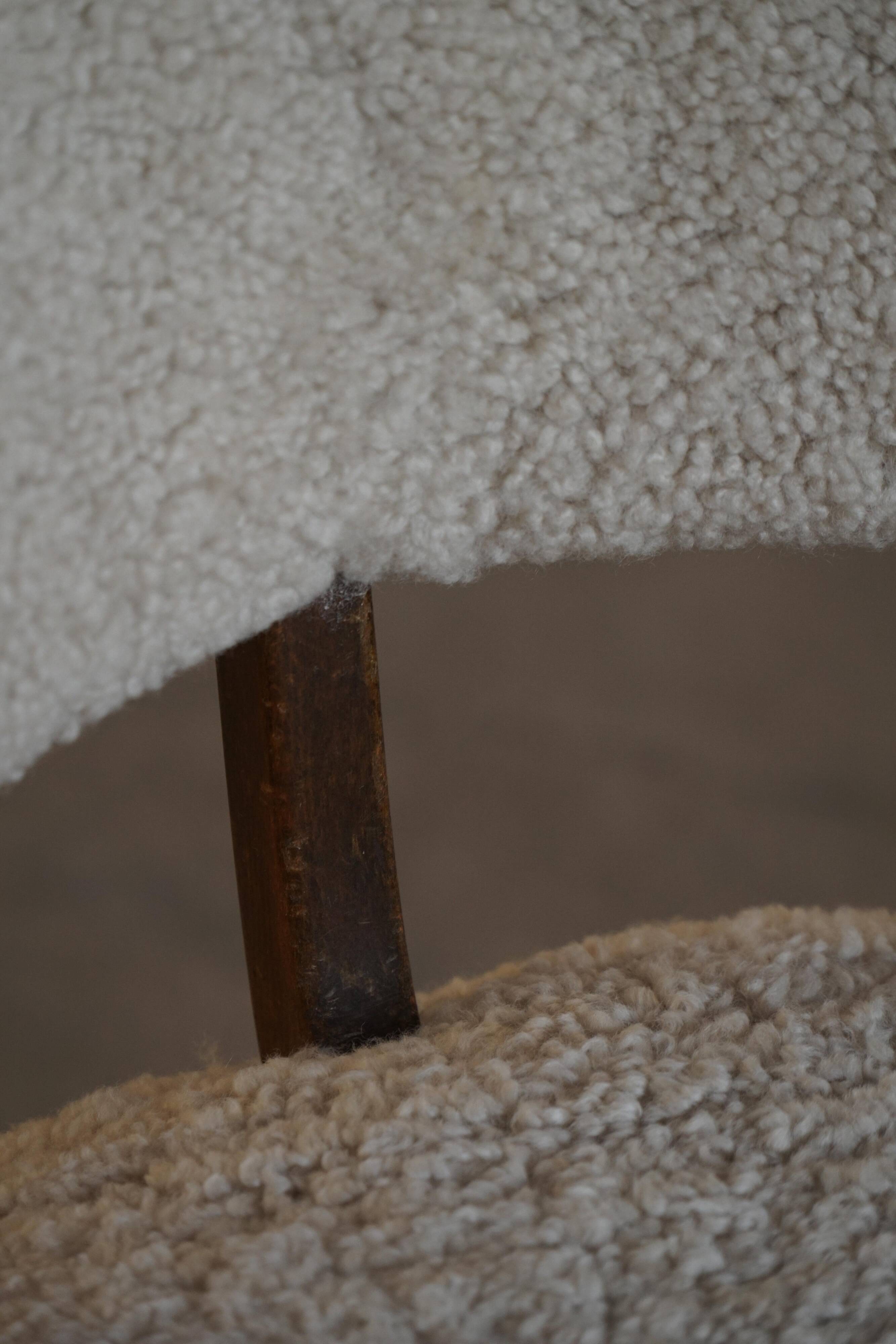 A modern Danish elegant low-back chair, reupholstered in lambswool, 1940s.