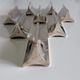 Eight Boulenger knife holders in art deco silver metal