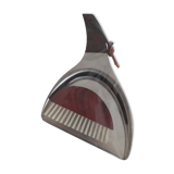 Picks up new vintage shovel and sweeper crumbs