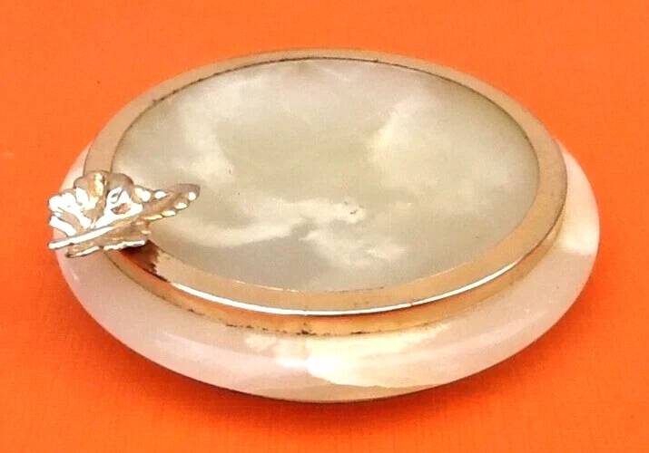 1970s Onyx ashtray with a gold metal rim.