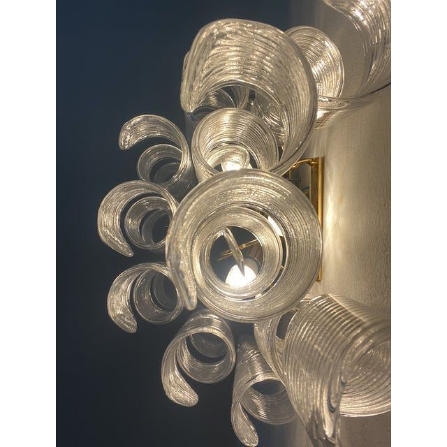 A pair of transparent “ricci” murano glass wall sconces