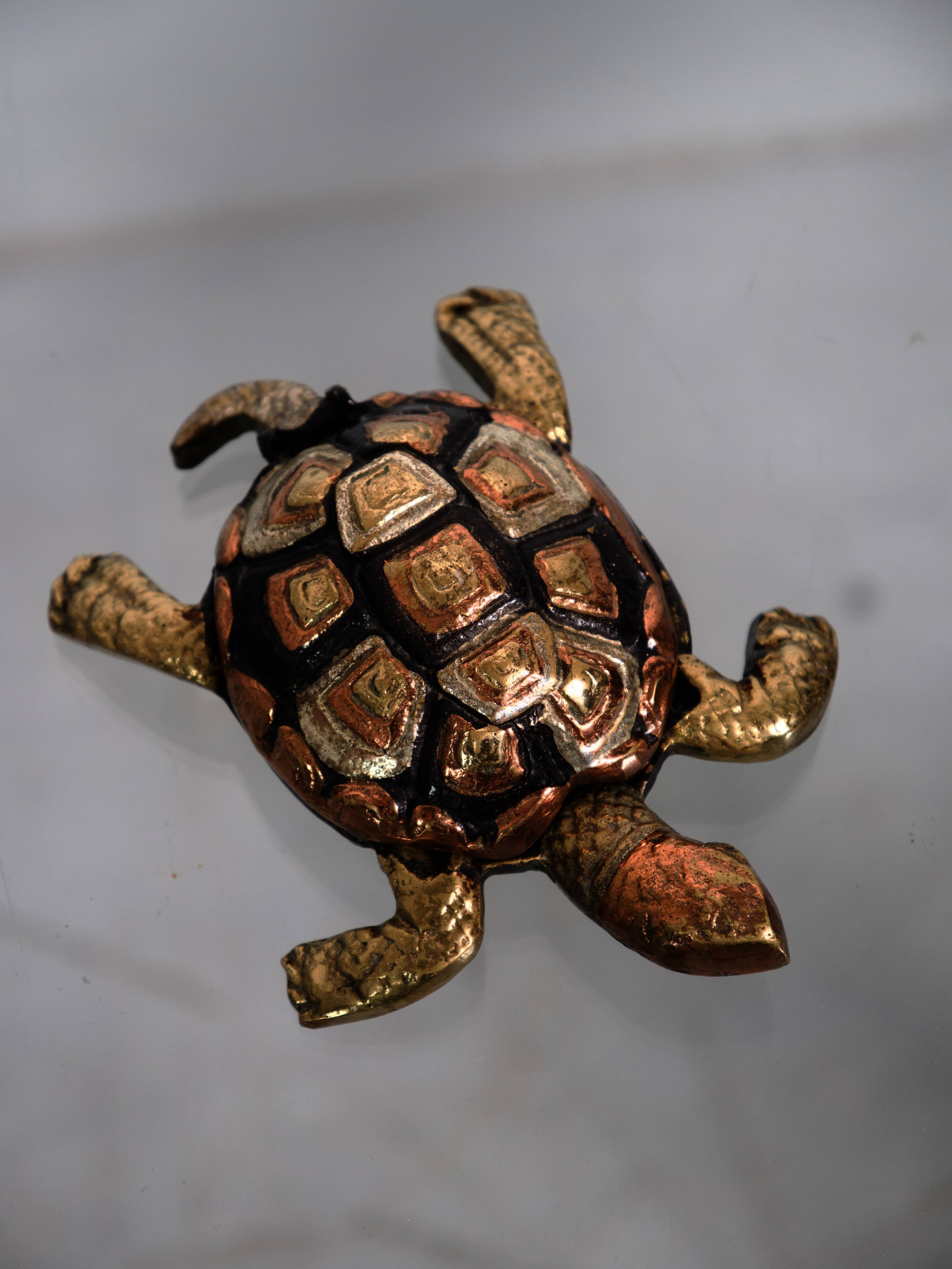Golden brass turtle in decorative ashtray