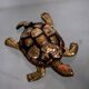 Golden brass turtle in decorative ashtray