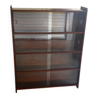 Vintage 1960s wooden library with sliding doors.