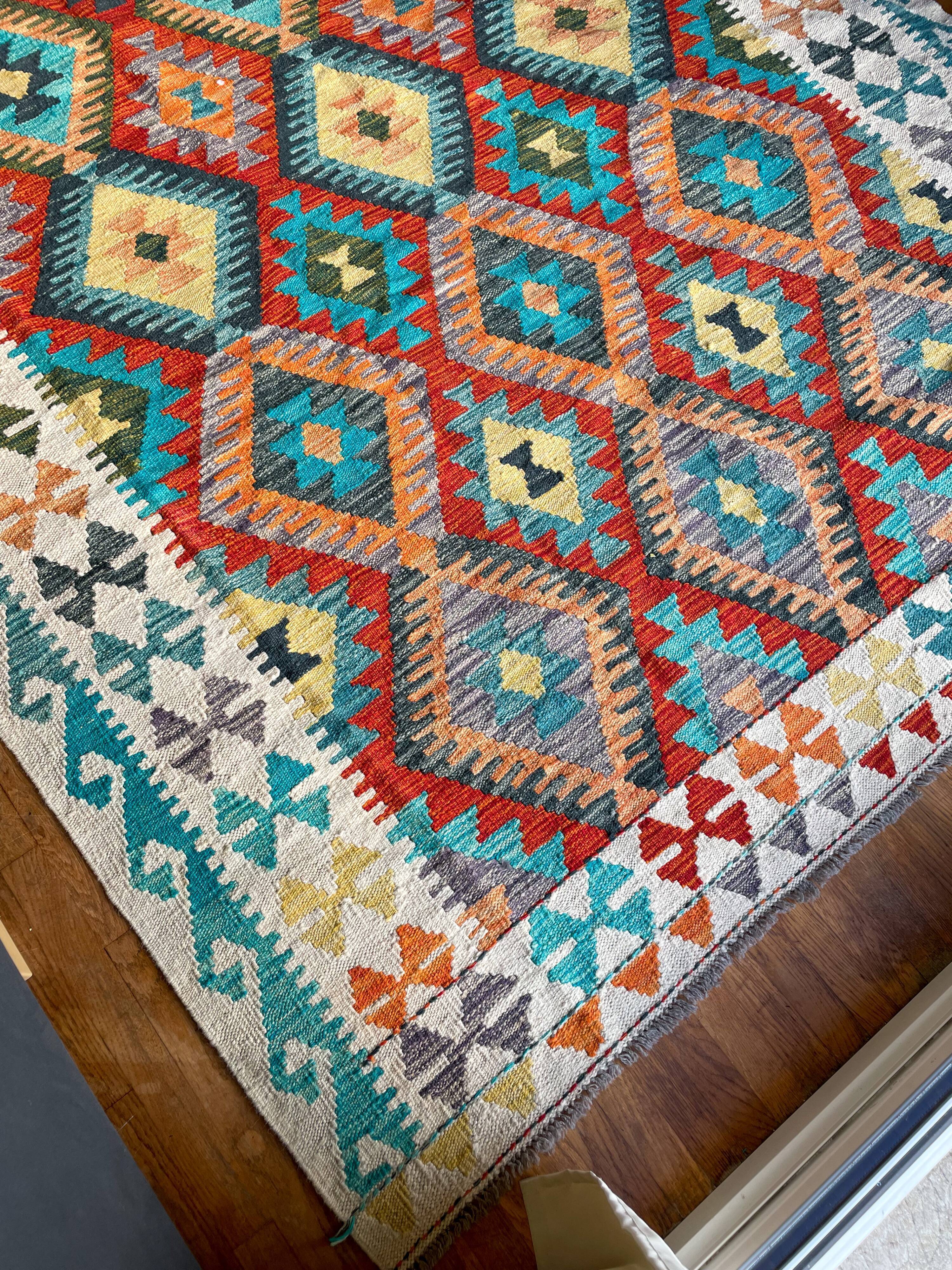 Oriental kilim rug afghan colored red and multicolored