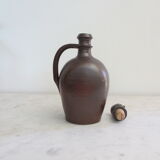 Sandstone pitcher, with anthropomorphic cap.