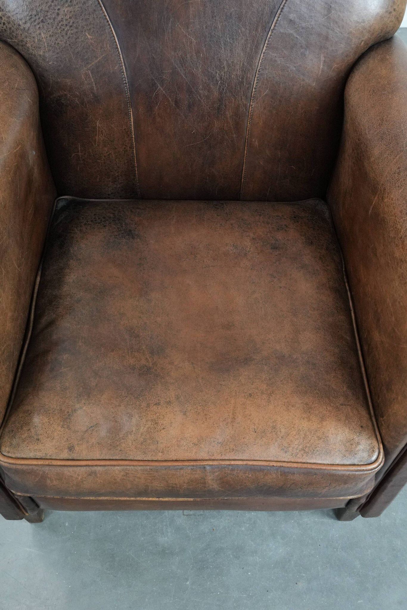 Vintage sheepskin armchair with warm colours and a characterful appearance