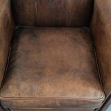Vintage sheepskin armchair with warm colours and a characterful appearance