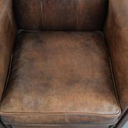 Vintage sheepskin armchair with warm colours and a characterful appearance
