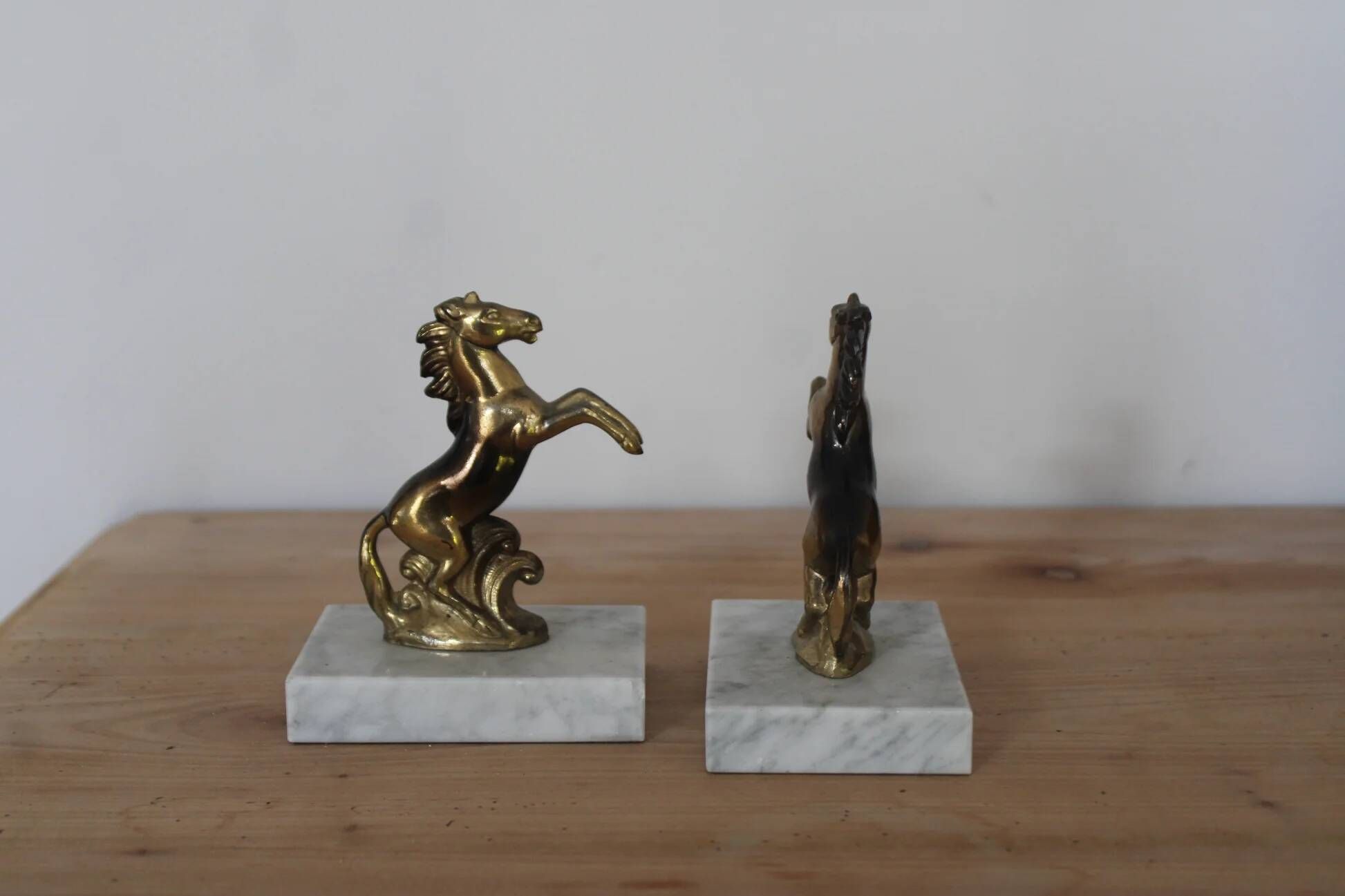 Pair of vintage bookends with rearing horses in gilded metal on marble bases.