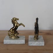 Pair of vintage bookends with rearing horses in gilded metal on marble bases.