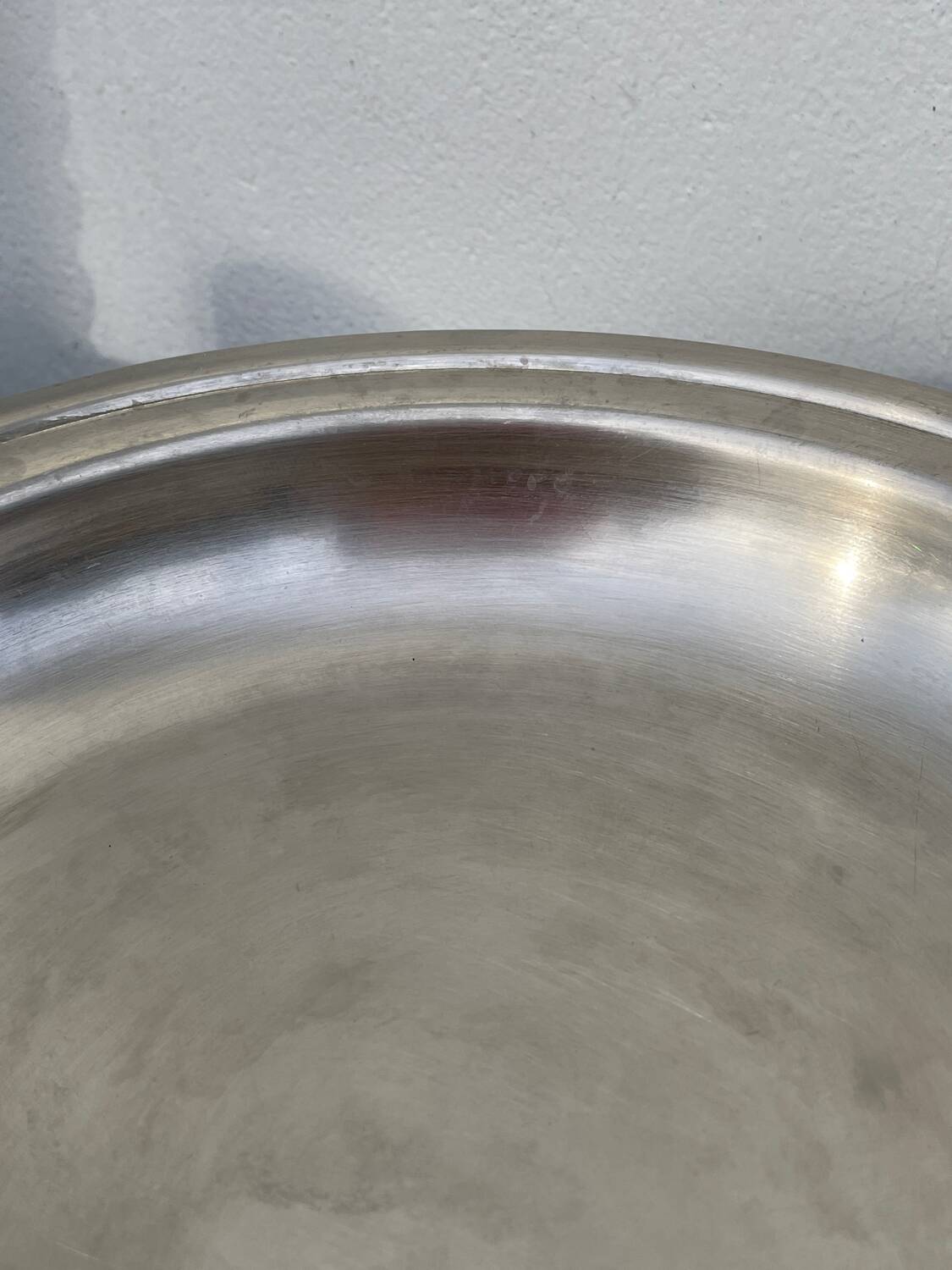 Round silver-plated metal serving dish with hallmark