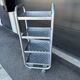 Four-wheeled dessert trolley with 4 perforated metal shelves.