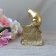 Golden brass cat figurine on fence looking at a mouse in a Vintage India shoe