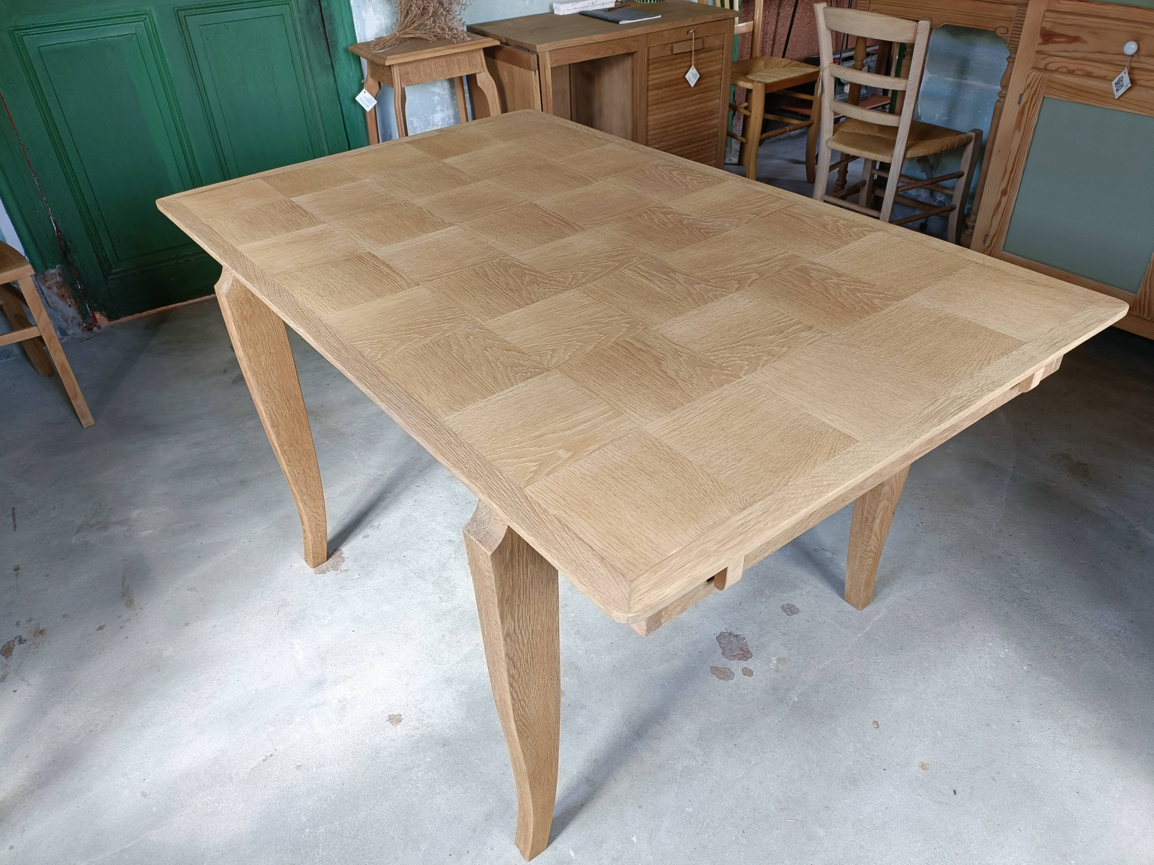 Oak dining table with a checkerboard top and extensions.