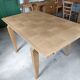 Oak dining table with a checkerboard top and extensions.